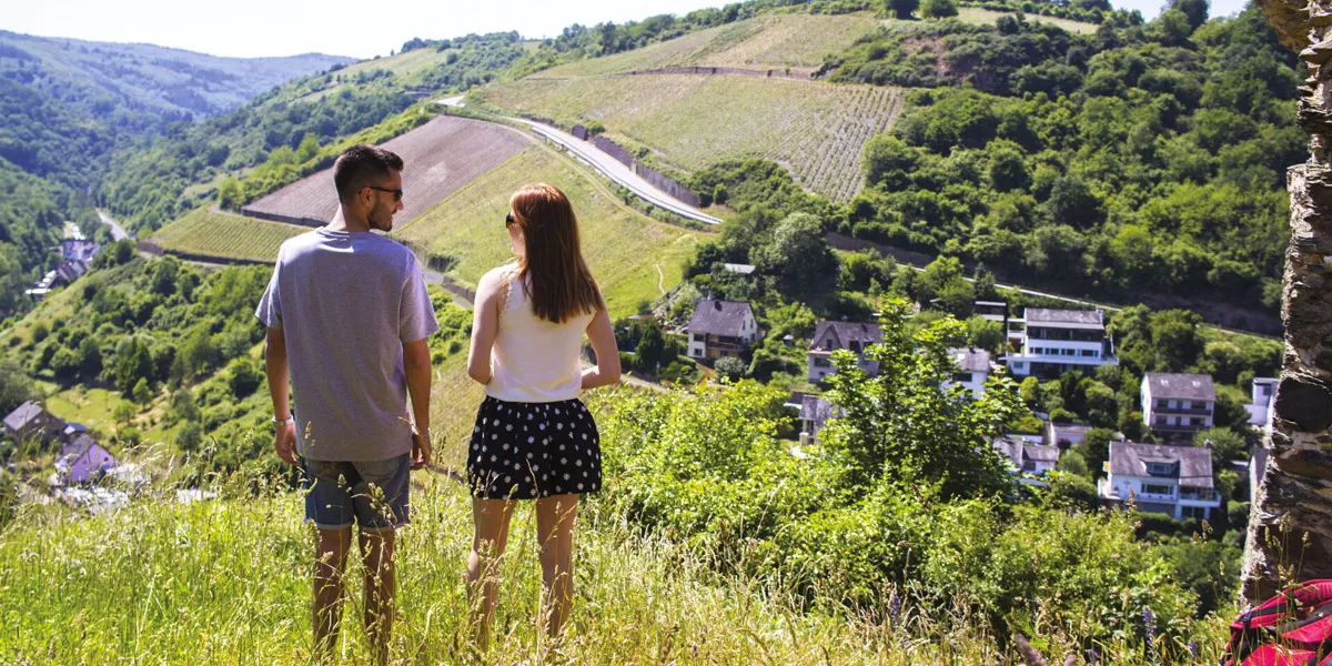 Two People Looking At A Valley Nature Around Them