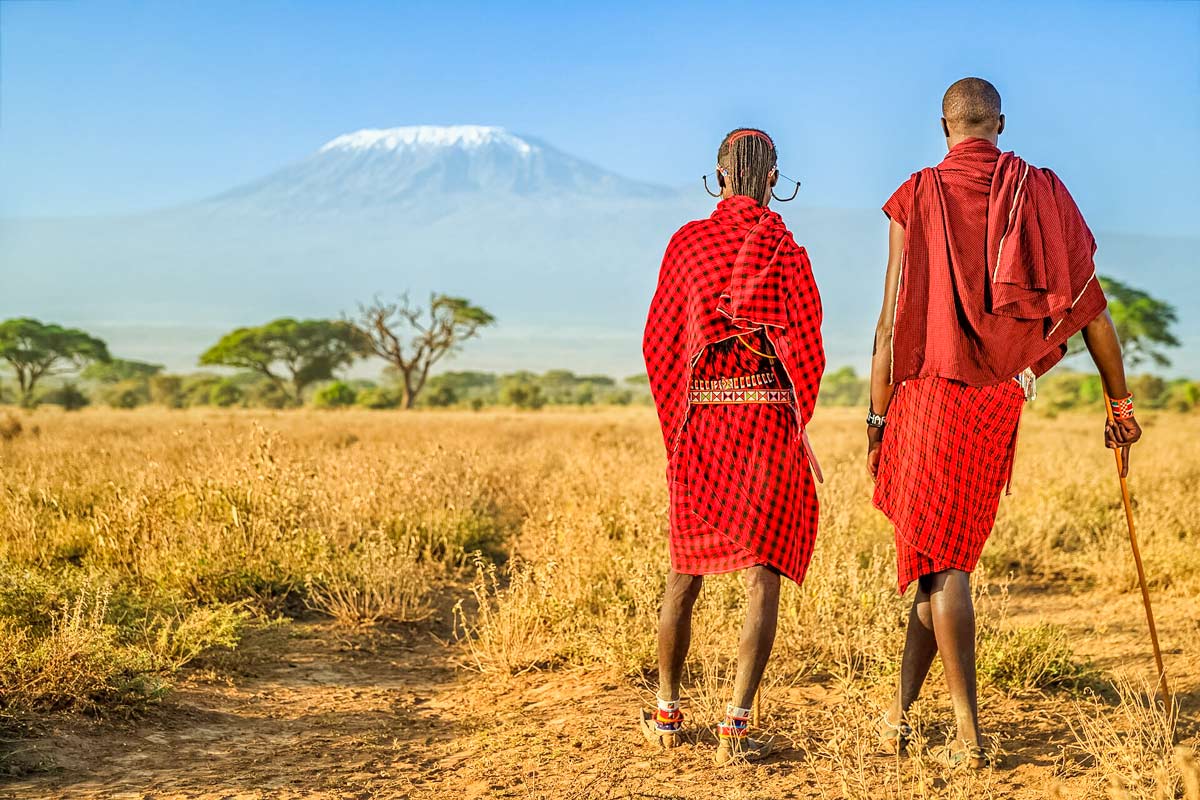 Warriors From Maasai Tribe Looking At Mount Kilimanjaro