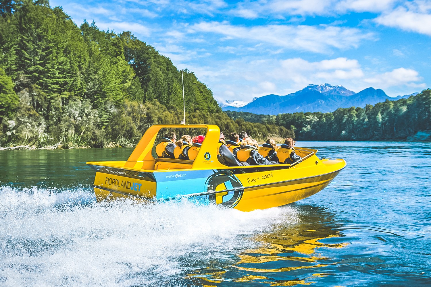 Yellow Jet Boat on the water creating a wake