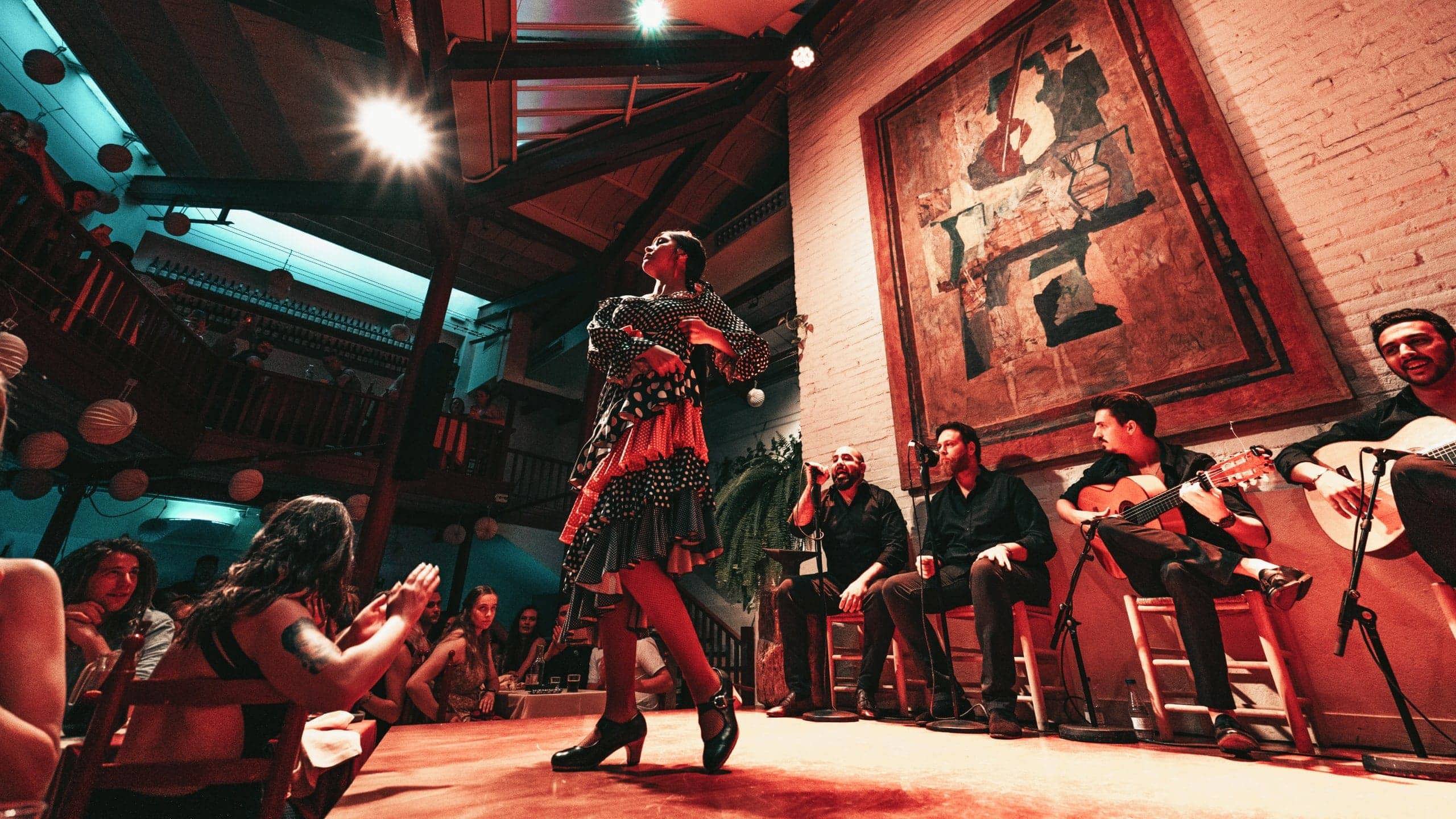 A flamenco dancer performs alongside live musicians as travellers watch an evening show on the Contiki Barcelona to Lisbon Tour