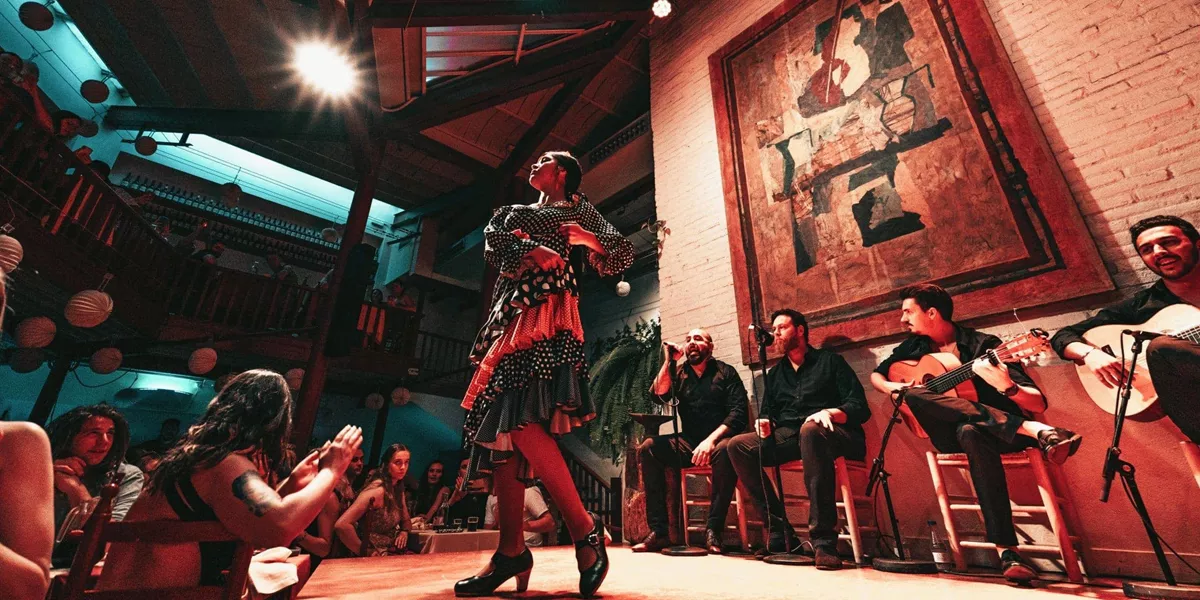 A flamenco dancer performs alongside live musicians as travellers watch an evening show on the Contiki Barcelona to Lisbon Tour