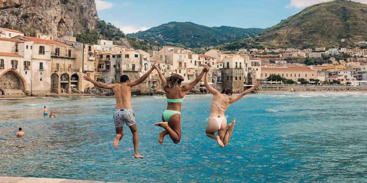 Travelers Jumping Into Sea Sicily