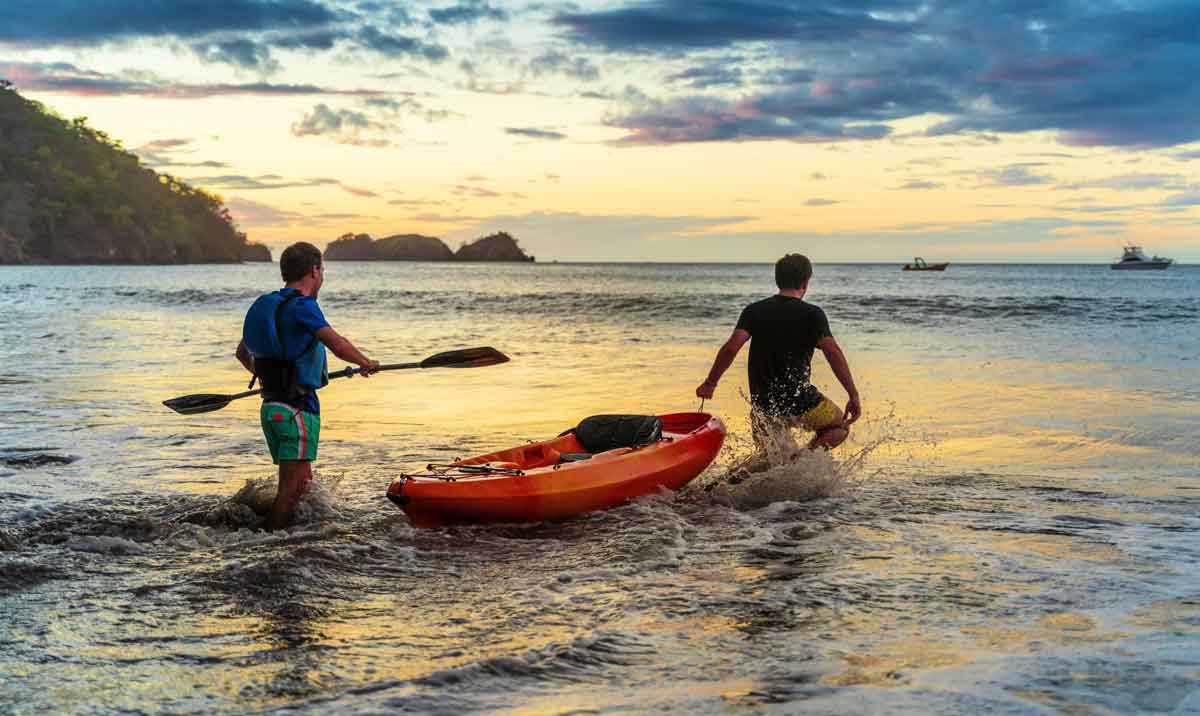 Best Friends Putting A Kayak Into The Waves Costa Rica