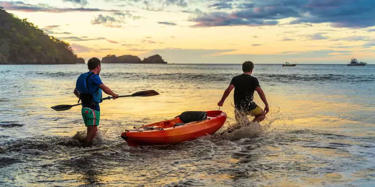 Best Friends Putting A Kayak Into The Waves Costa Rica