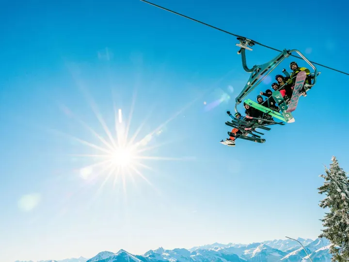 Group of skiers on ski left in the sunshine