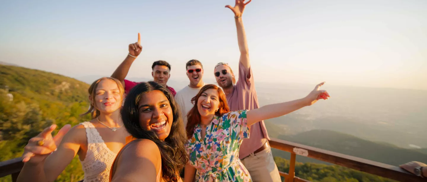 Group Of Young People Smiling With View Behind Them