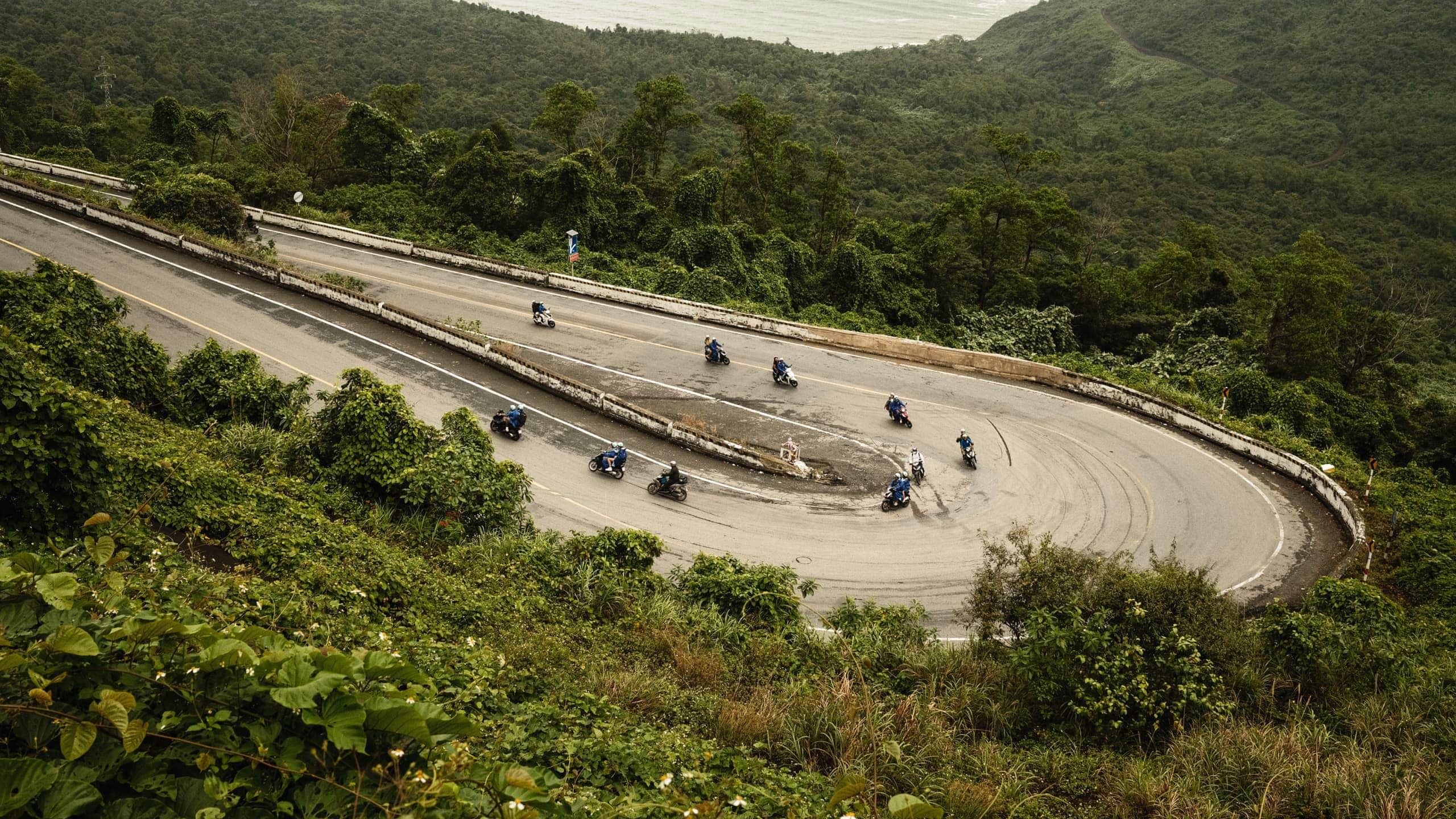 Contiki travellers riding scooters along Vietnam's iconic Hải Vân Pass on Contiki's Ride Vietnam Tour
