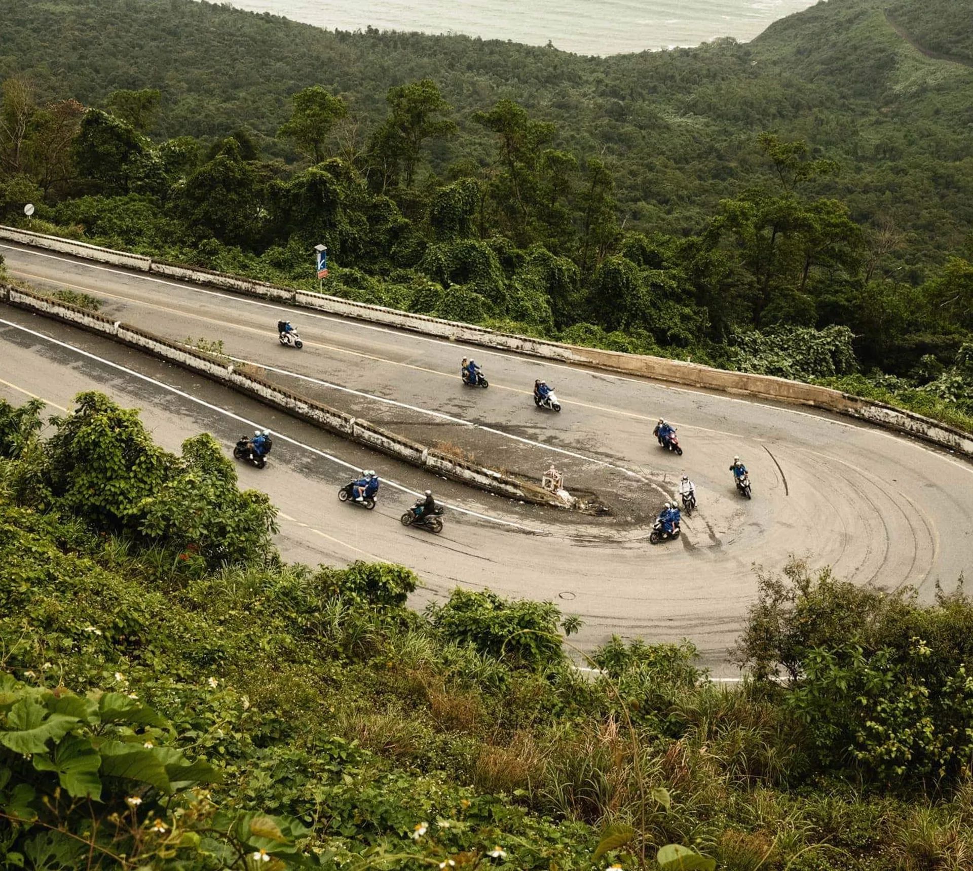 Contiki travellers riding scooters along Vietnam's iconic Hải Vân Pass on Contiki's Ride Vietnam Tour