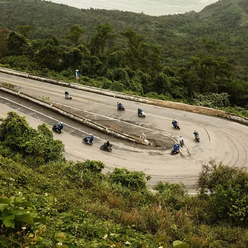 Contiki travellers riding scooters along Vietnam's iconic Hải Vân Pass on Contiki's Ride Vietnam Tour