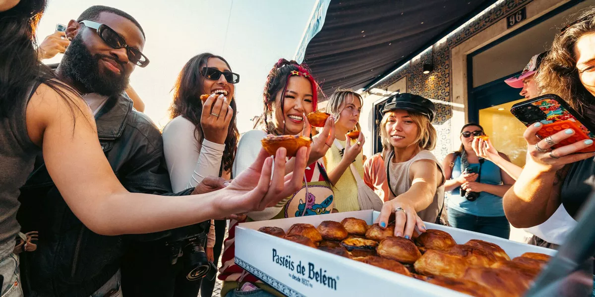Group Of Young Friends Enjoying Pastry From Portugal