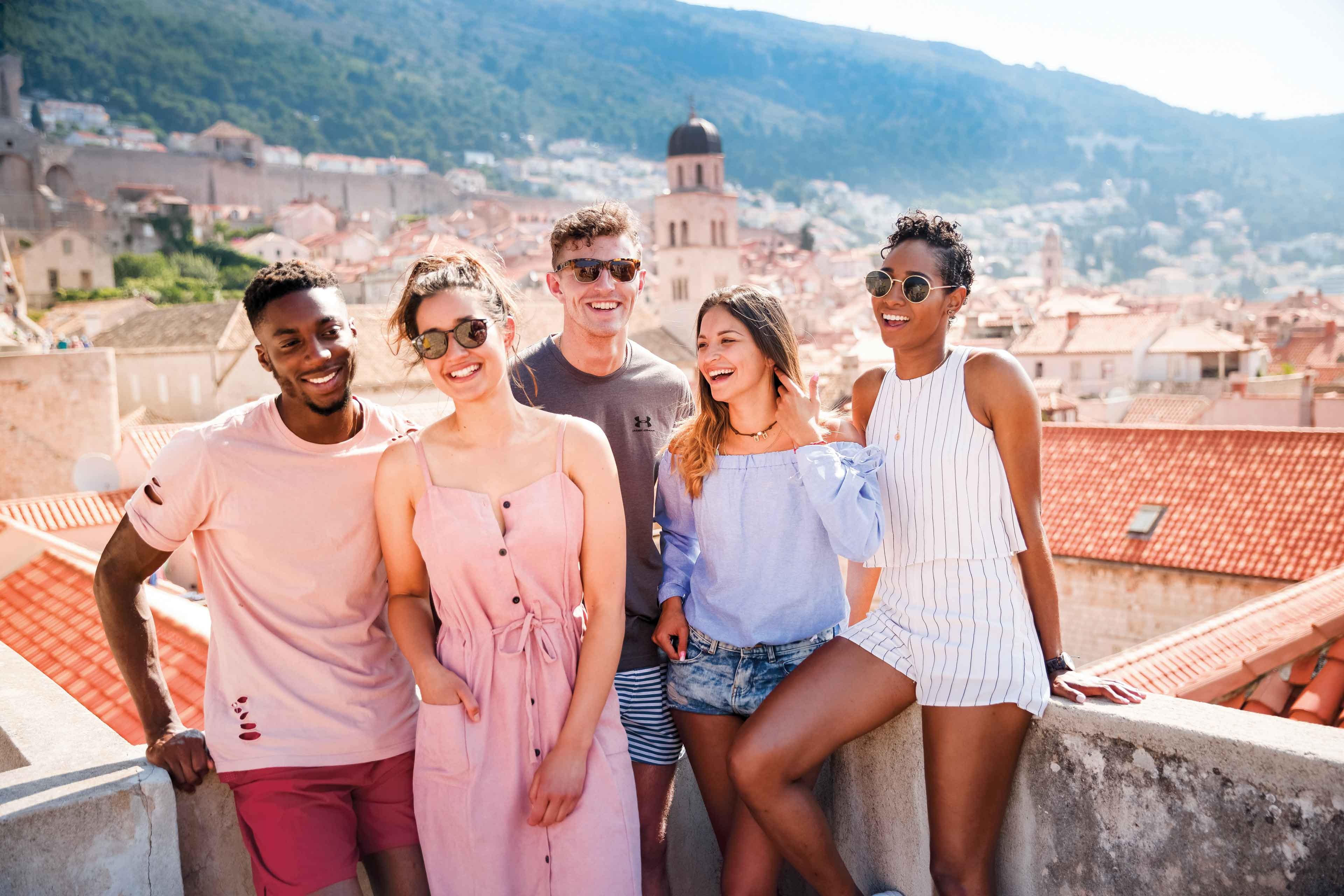 Group Of Young Contiki Travelers Enjoying The Colosseum, Rome, Italy