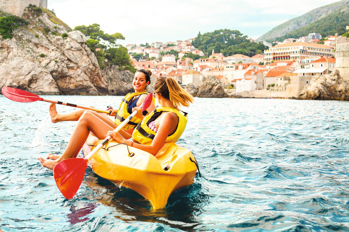 Two Women Smiling In A Boat Blue Sea Sunny Day