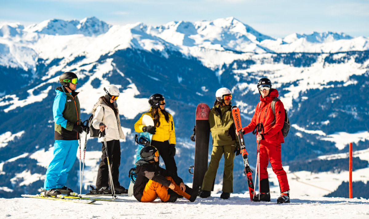 Group Of People Wearing Ski Equipment On A Snow Mountain