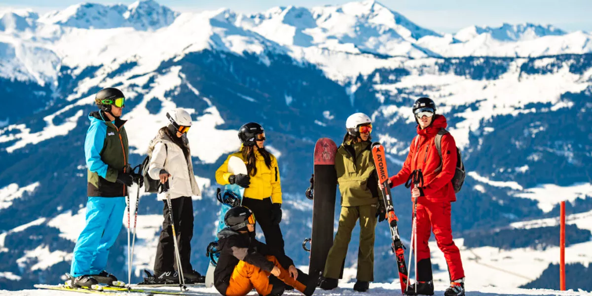 Group Of People Wearing Ski Equipment On A Snow Mountain