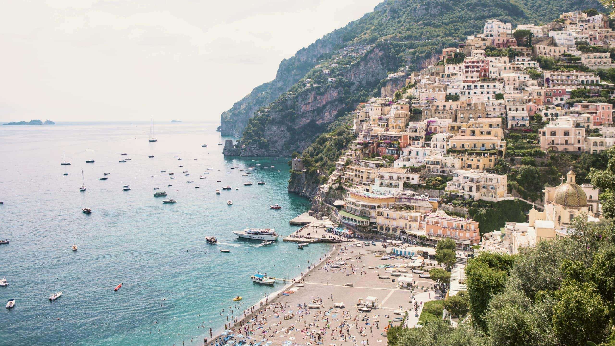 Panoramic view of Positano's colourful cliffside village and beach on the Amalfi Coast during the Contiki Amalfi Coast Tour