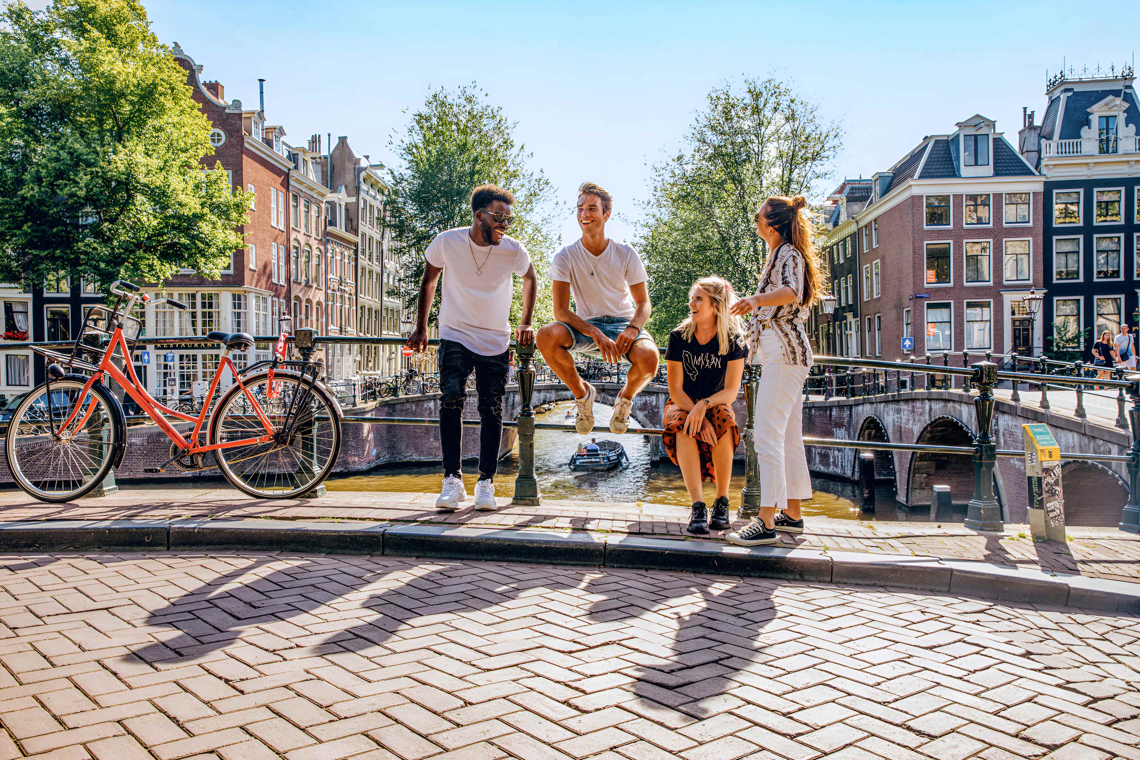 A group of people are enjoying a sunny day in Amsterdam.