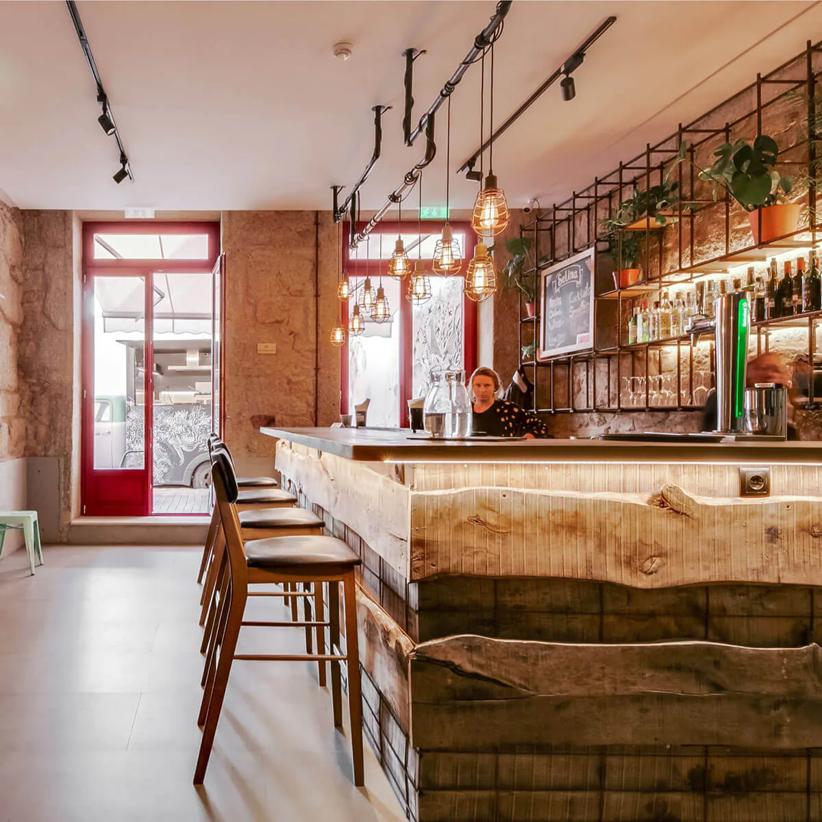 A woman working behind a wooden bar