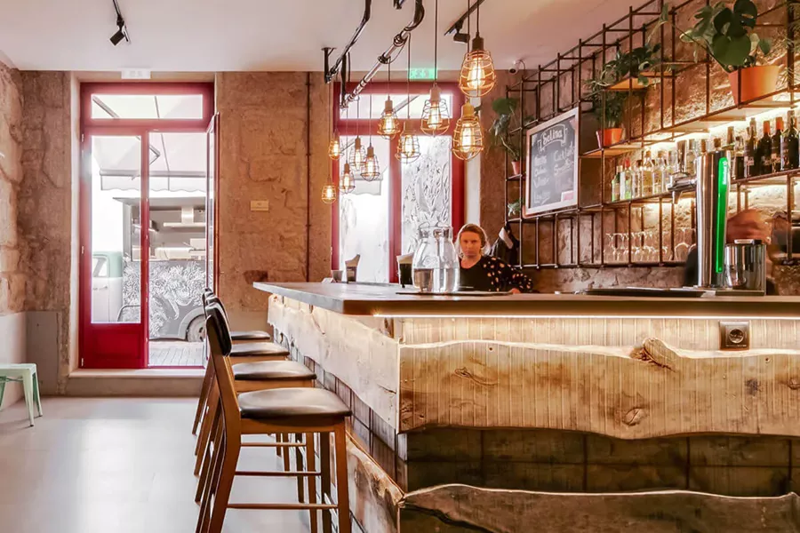 A woman working behind a wooden bar