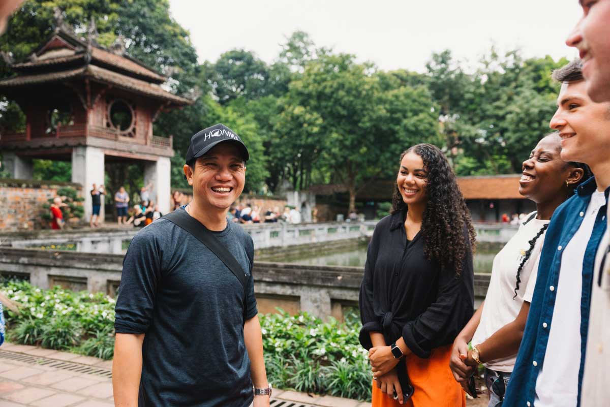 People Smiling Temple At The Back Green Trees