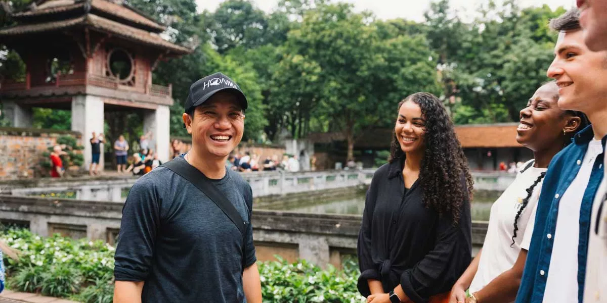 People Smiling Temple At The Back Green Trees