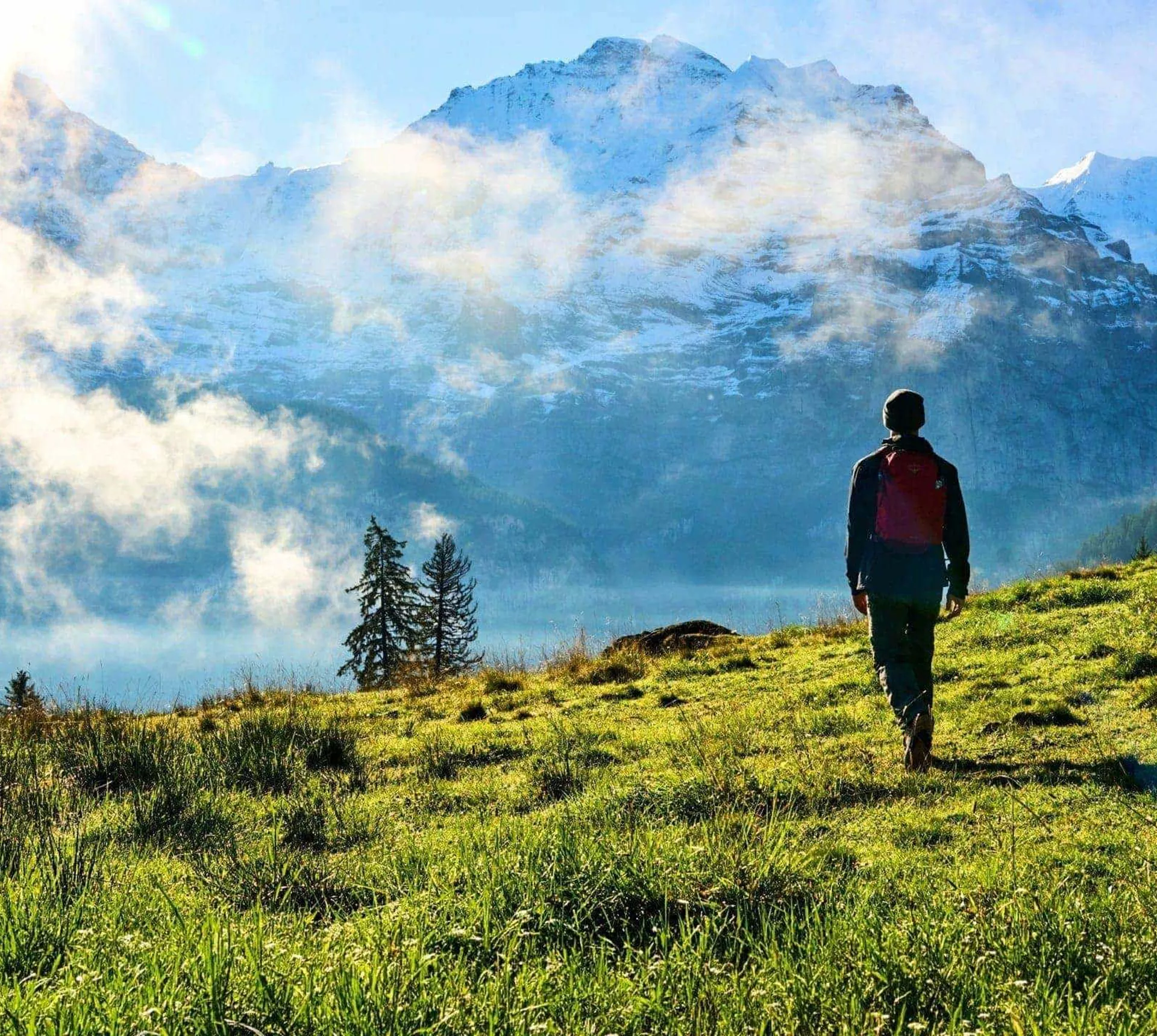 Traveller hiking through the Austrian Alps with panoramic mountain views on the Contiki Active Austrian Alps Tour