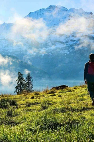 Traveller hiking through the Austrian Alps with panoramic mountain views on the Contiki Active Austrian Alps Tour