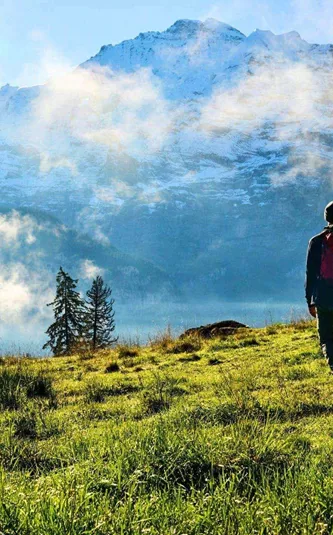 Traveller hiking through the Austrian Alps with panoramic mountain views on the Contiki Active Austrian Alps Tour