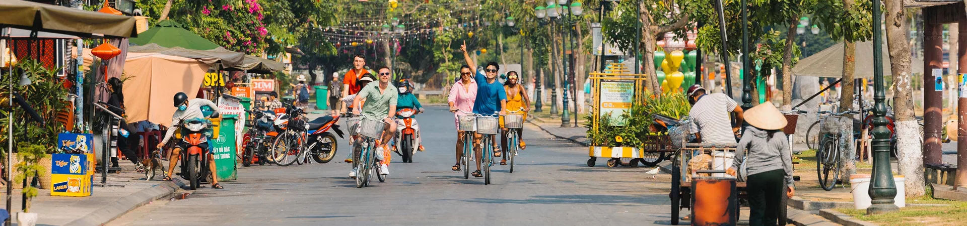 Group Young Travellers Riding Bikes Through Thailand