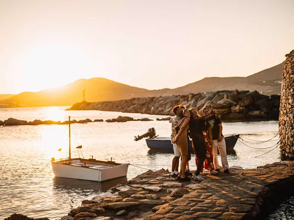 Group Of Young Travelers Taking Selfie At Sunset In Greece