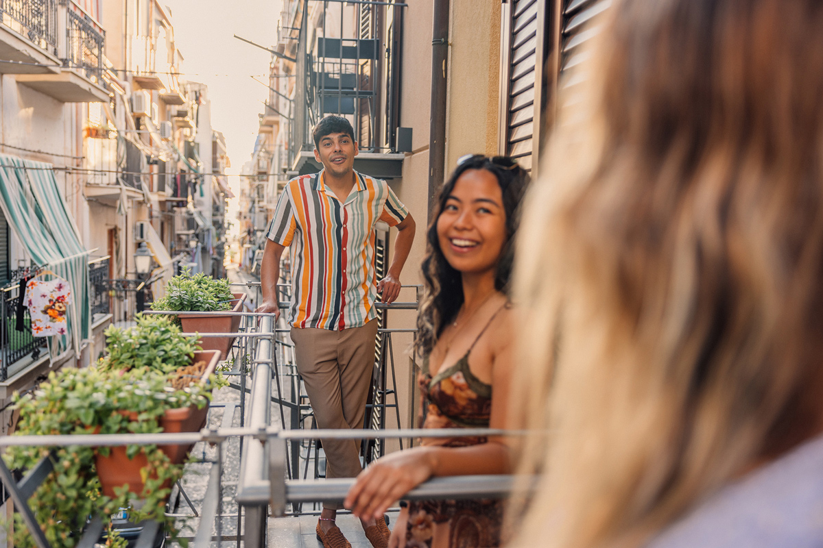 faq-tile-friends-chatting-on-balconies-in-sicilian-street.jpg