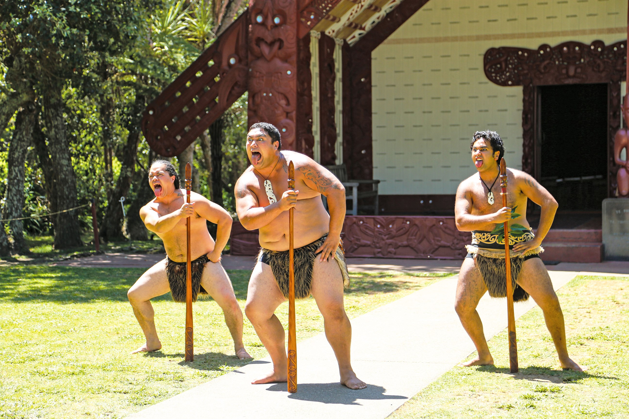 Māori performing a tradition ceremony welcoming visitors onto the Marae in New Zealand