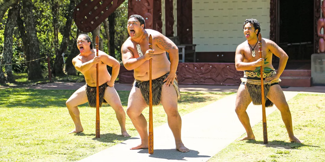 Māori performing a tradition ceremony welcoming visitors onto the Marae in New Zealand