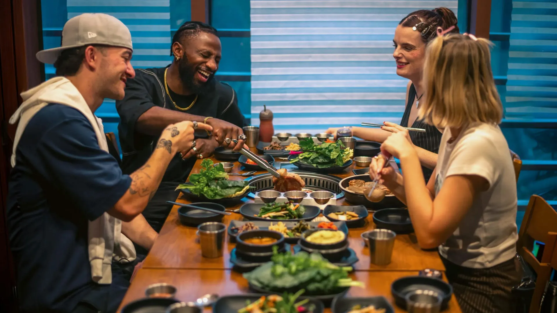 Contiki group enjoying Korean barbecue at a restaurant in Seoul, South Korea - Contiki's Best of South Korea Tour
