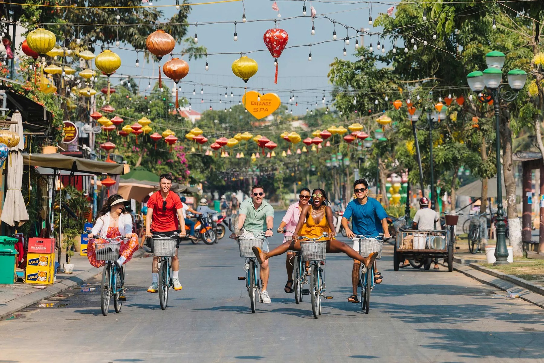 Group of young people riding bikes in a road in Vietnam