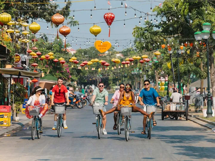 Group of young people riding bikes in a road in Vietnam