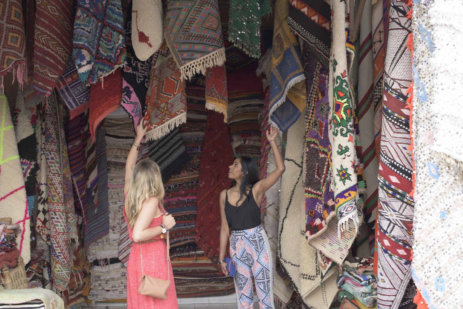 Women in the market, carpets in the background
