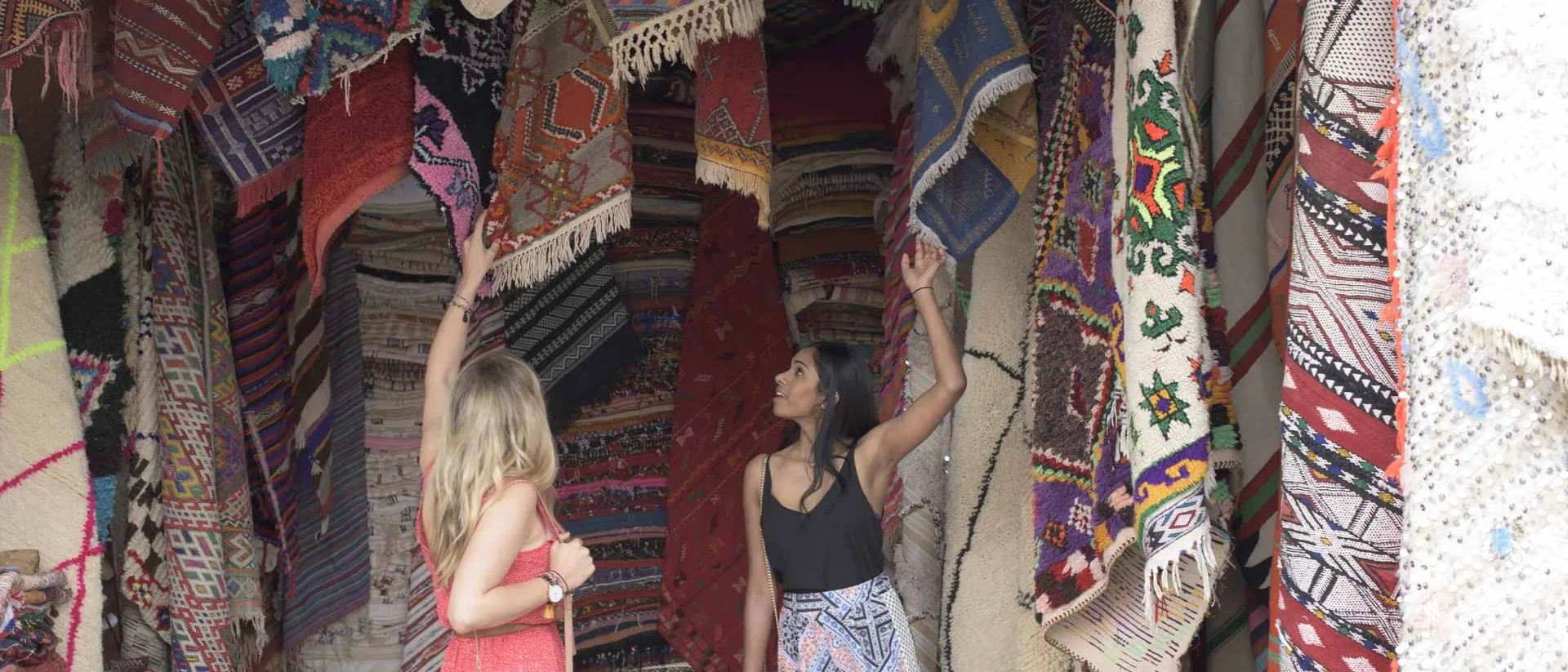 Women in the market, carpets in the background
