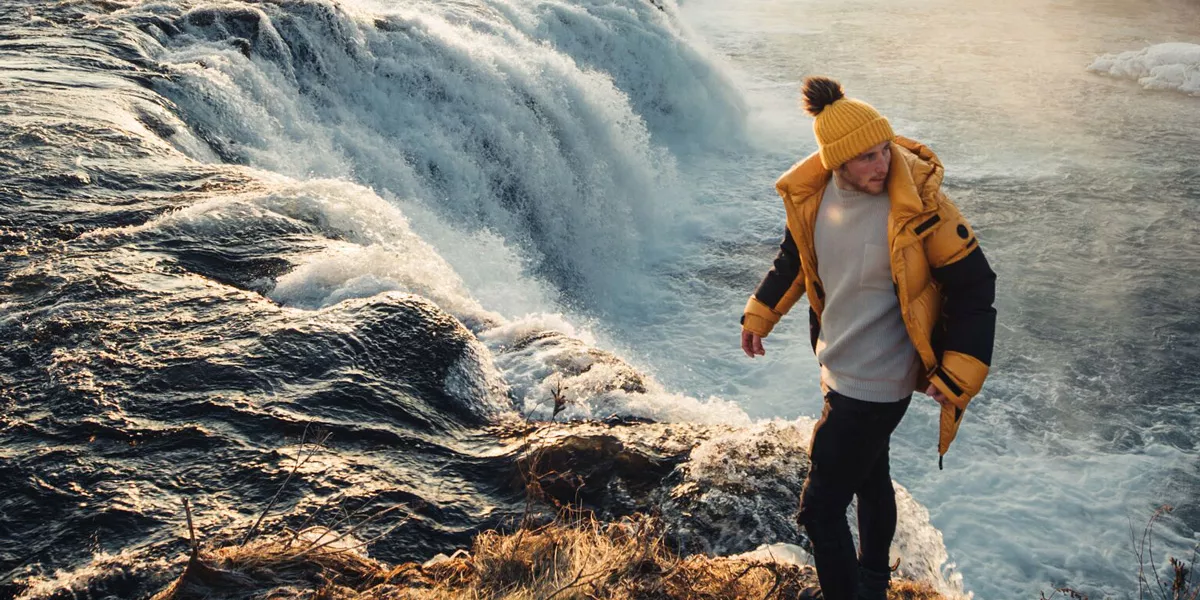 Man Walking Close To A Waterfall