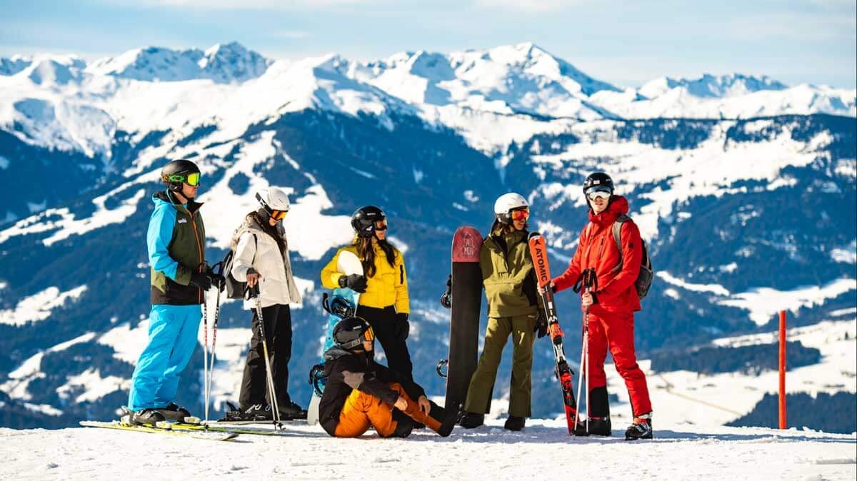 Group Of Skiers Snowboarders On Mountain