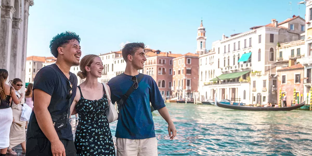 People Walking In Venice Close To Canal