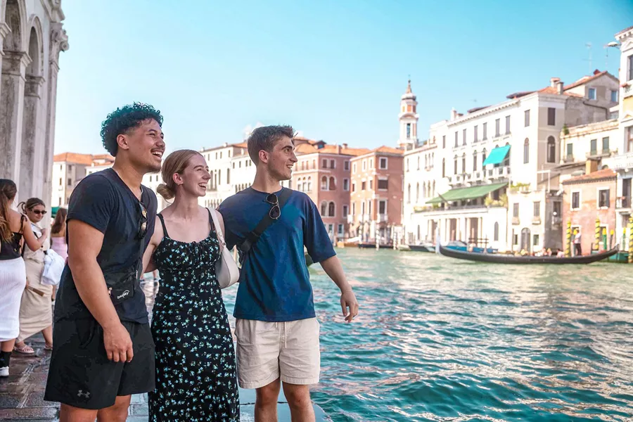 People Walking In Venice Close To Canal