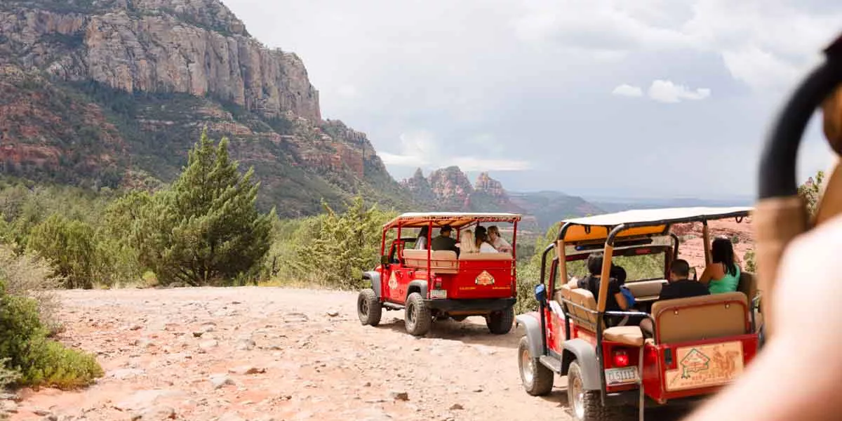 Group Of Travellers In Jeeps In Desert America Usa