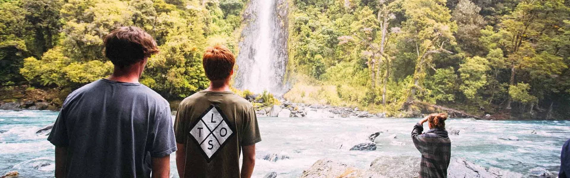 Group In New Zealand Near Waterfall