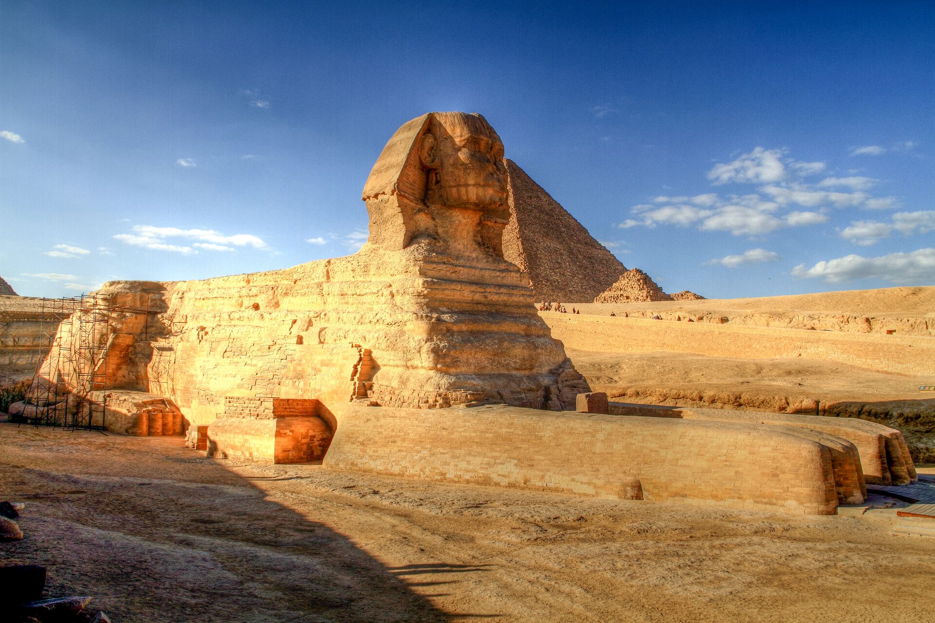 The Great Sphinx of Giza with Pyramids in the background on a sunny day, Egypt