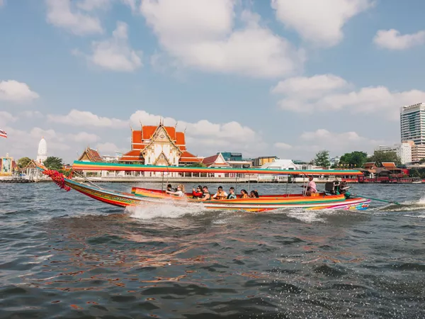 People Riding A Large Boat Sunny Day