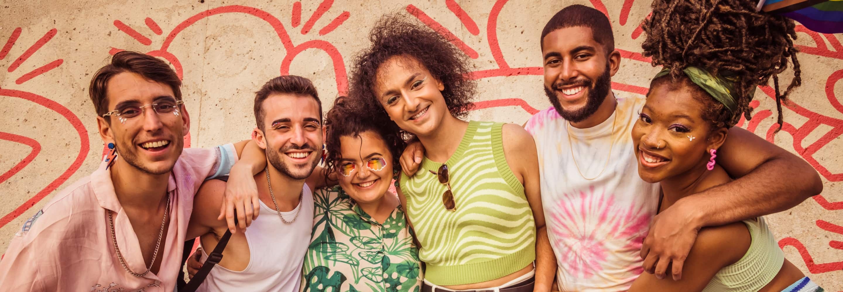 Friends posing in front of colorful wall art