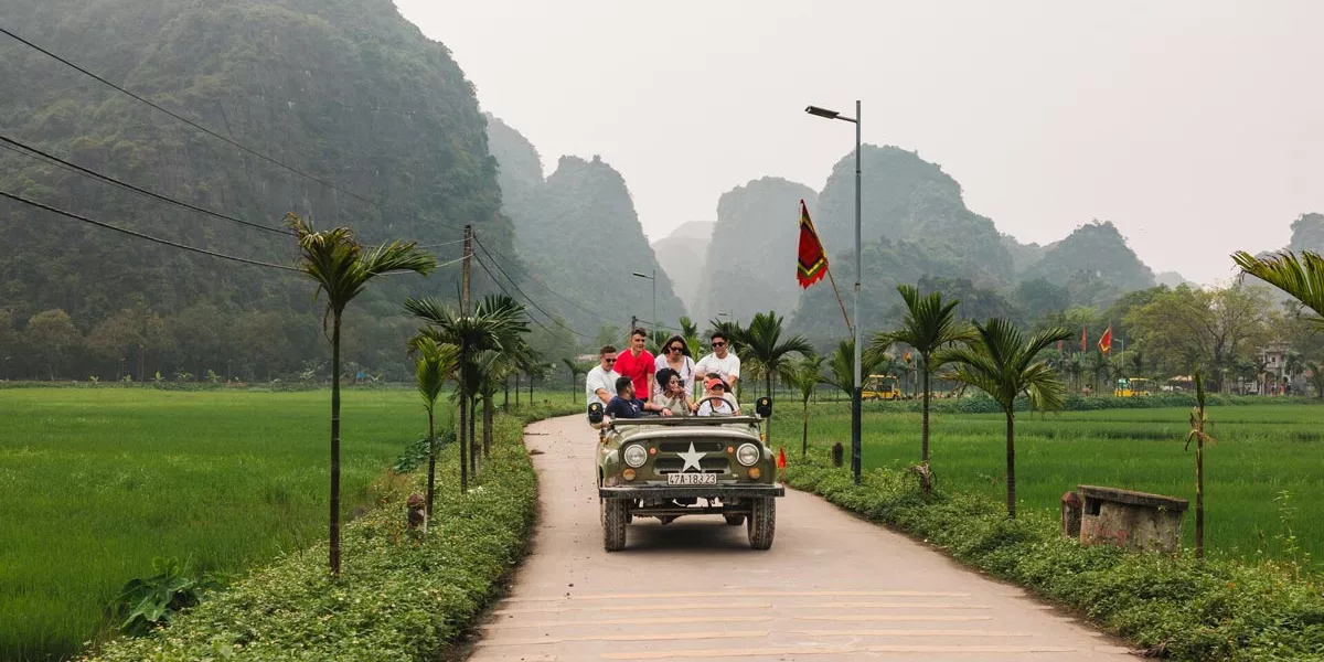 Friends Enjoying A Jeep Ride Green Mountains At The Background