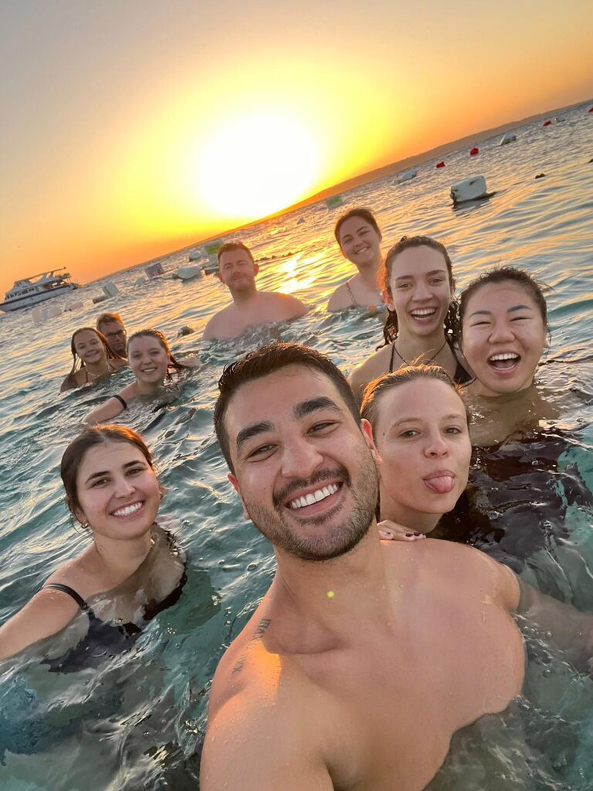 Friends smiling while swimming in Egypt.