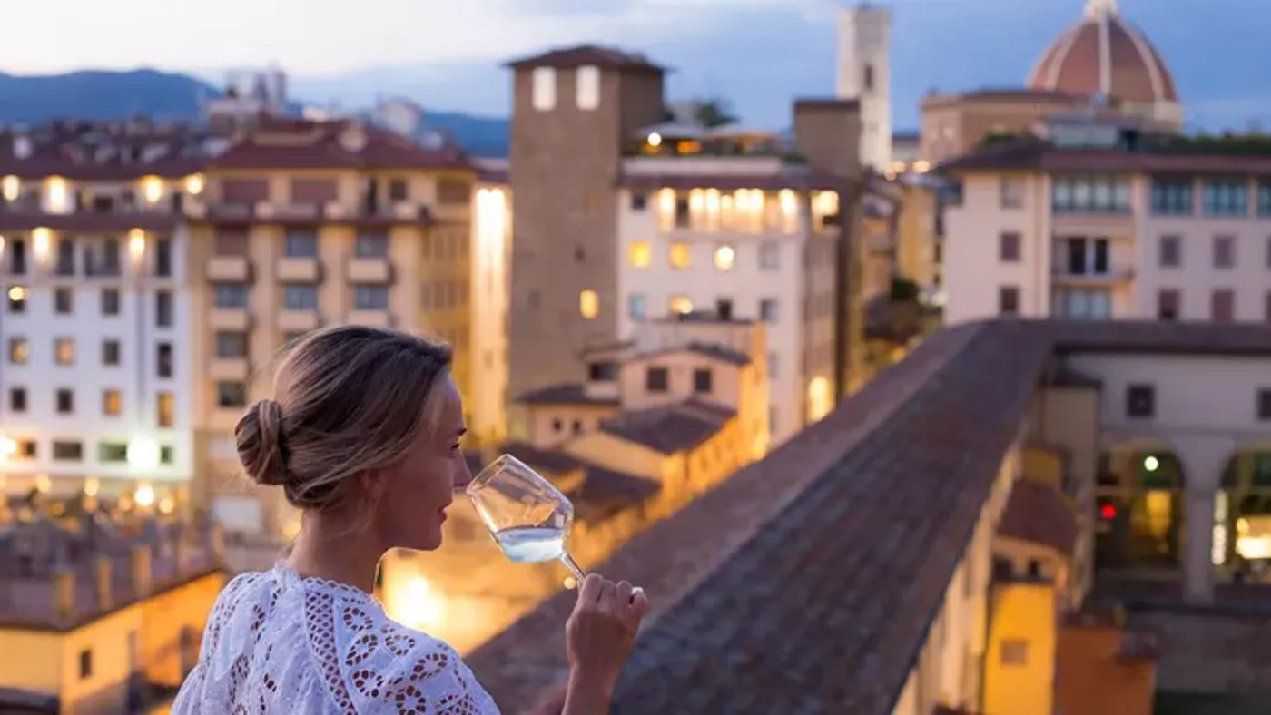 woman-in-beautiful-white-dress-enjoying-a-glass-of-wine-with-the-view-of-florence.jpg
