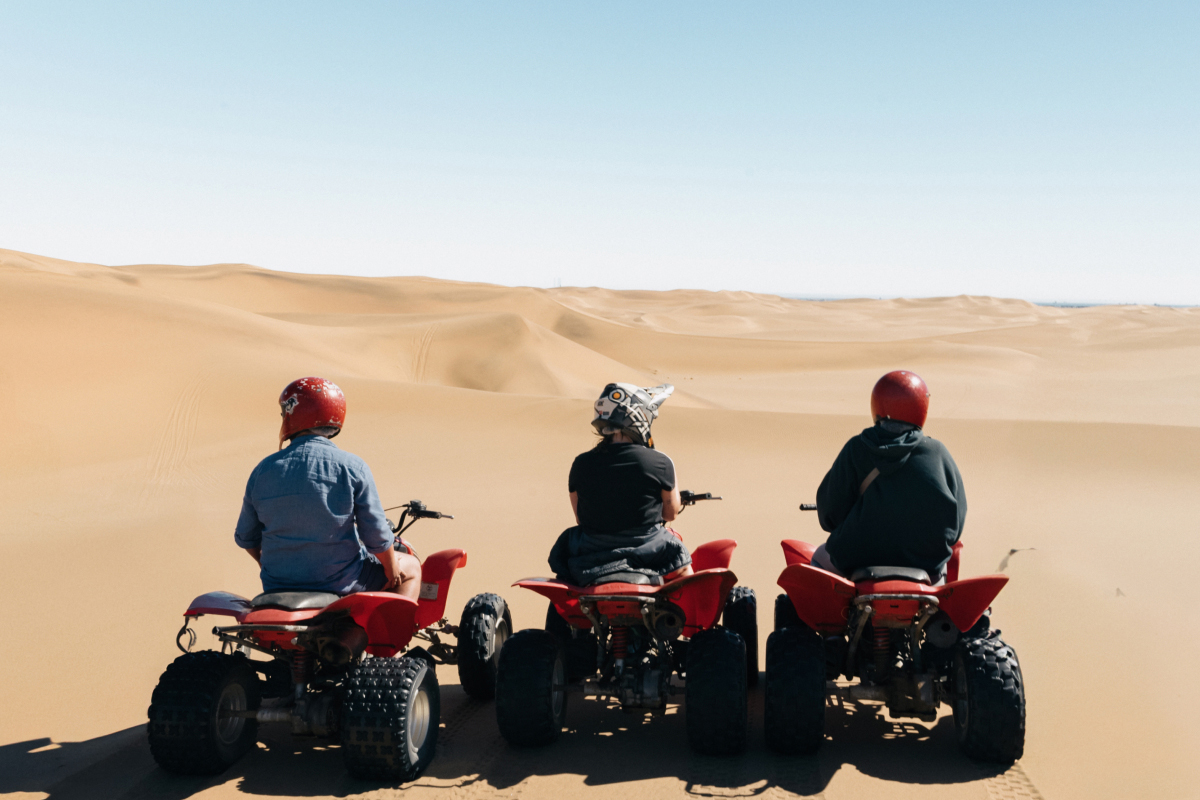 Three Women On Quadbikes On The Sand Dunes Of Kalahari Desert Botswana
